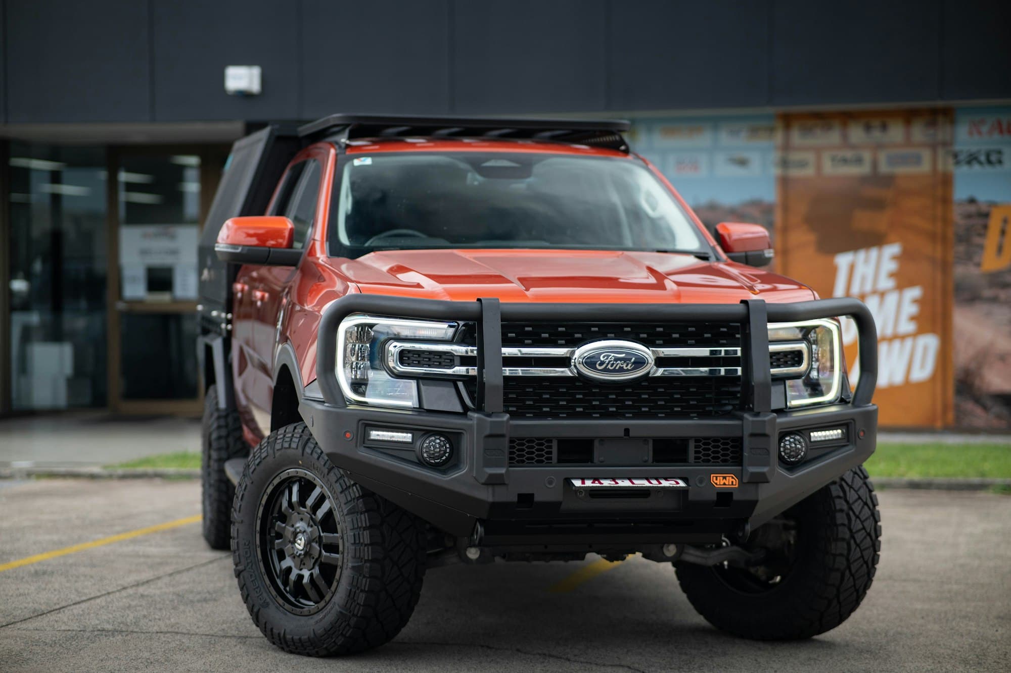 Orange Ford Ranger with bull bar and roof rack
