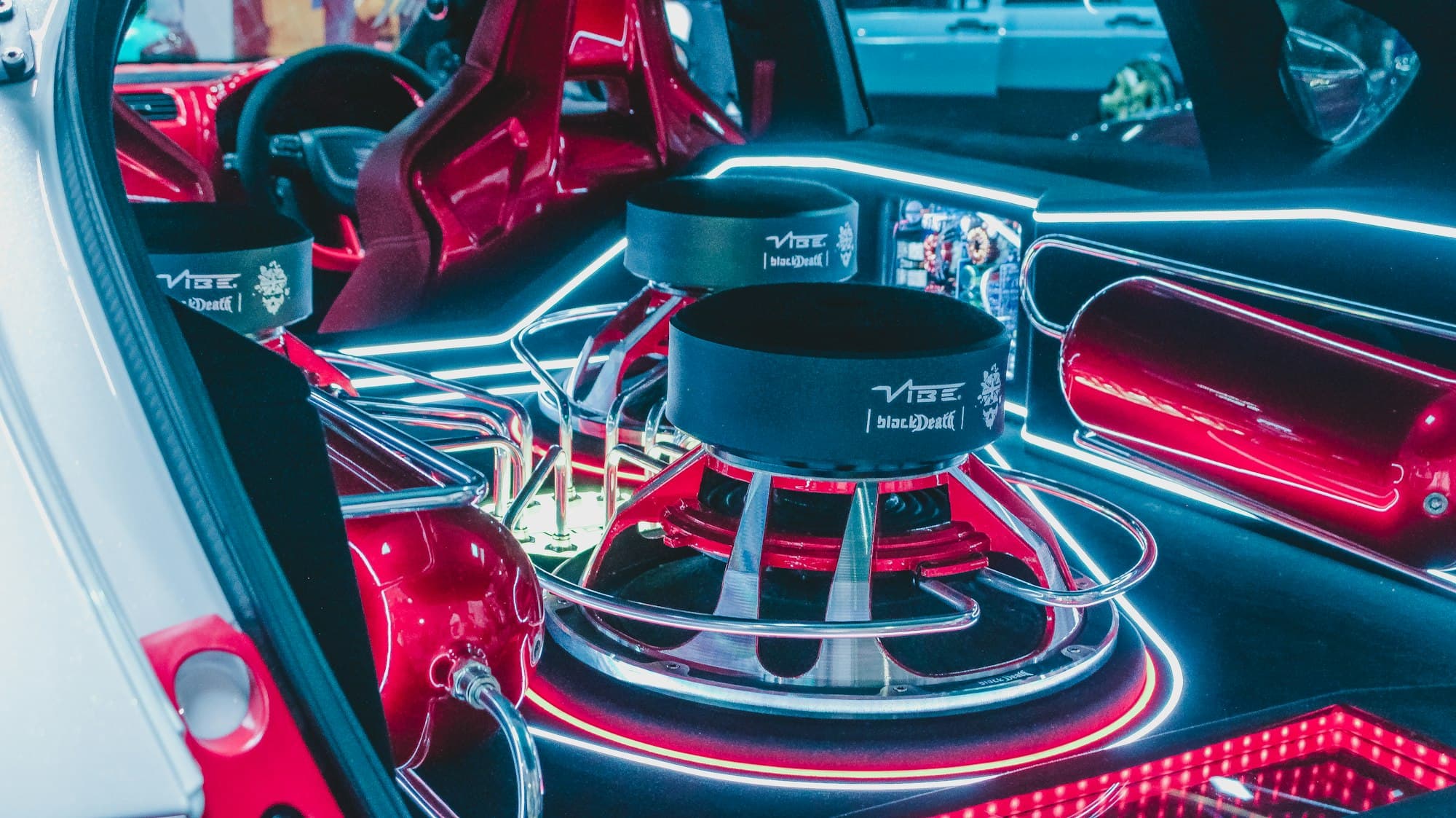 Custom subwoofer build in a car boot lit in neon